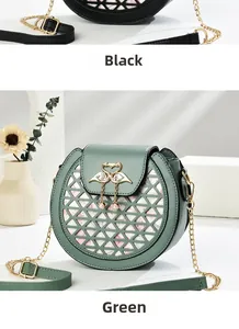 Detail of round crossbody bags in black and green with swan buckle and hollow triangle pattern