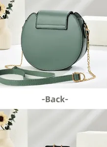 Detail view of the back of a dark green circular chain bag with textured synthetic leather