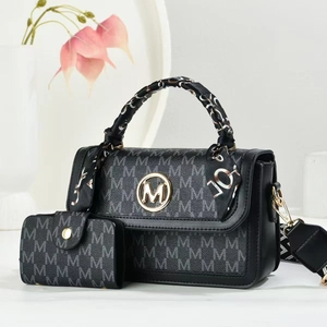 Detail of printed crossbody bag with gold M logo, floral scarf handle, and coin purse