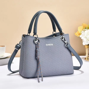 Close-up of blue woven texture tote bag with GIENRUTSR logo and elegant top handles