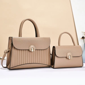 Detail of elegant khaki striped tote bag set with horsebit hardware and leather texture