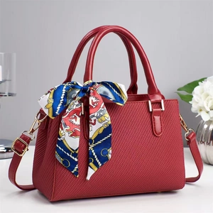 Deep red quilted leather handbag with chic floral scarf handle and gold hardware