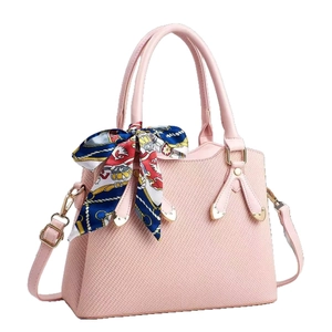 Pink woven handbag with printed silk scarf and adjustable strap for women in a 45-degree view