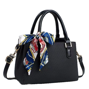 Classic black textured handbag with printed silk scarf and adjustable gold-tone strap