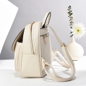 Minimalist cream white leather backpack for women with light gold metal hardware accents