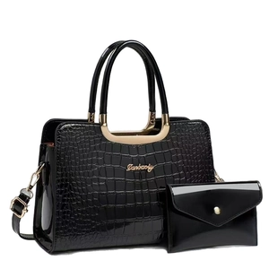 Two-piece black faux crocodile skin handbag set with metallic top handles and envelope wallet