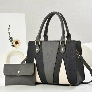 Detail of tricolor leather tote bag set with lychee grain texture and gold hardware