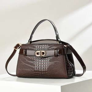 Dark brown faux crocodile leather handbag with golden hardware and structured retro design