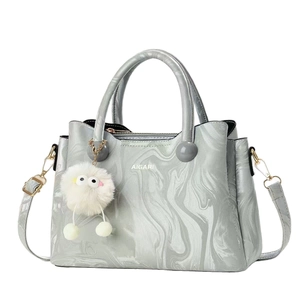 Silver marble pattern tote bag with plush charm and detachable shoulder strap in 45-degree view