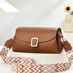 Brown litchi leather shoulder bag with gold hardware and geometric patterned strap