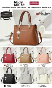 Detailed view of crossbody bag with size specs 24x11x19cm and detachable charm