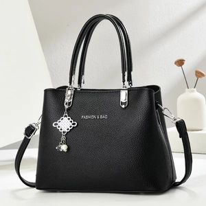 Classic black leather crossbody bag with silver hardware and pearl knot accessory