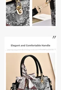 Detail of black lace print handbag featuring premium gold hardware and silk scarf decor