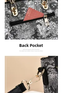 Detail of rear zipper pocket and gold lobster clasp on black floral embroidered bag