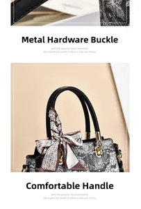 Detail of elegant gold hardware clips and comfortable black leather handle with silk scarf
