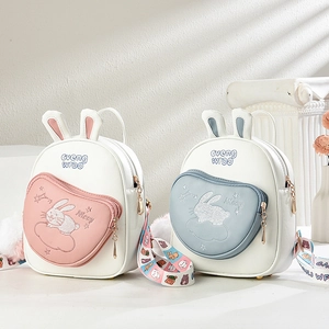 Detail of cute bunny backpacks with rabbit ear designs and colorful printed straps