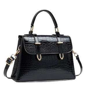 Black crocodile pattern handbag with gold hardware and top handle shown in main view