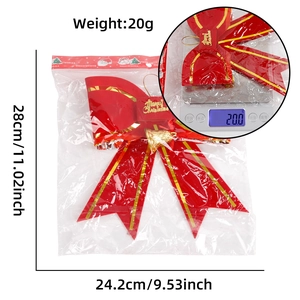 Detail of red Christmas bow with bells, packaged with size and weight measurements