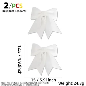 Set of two white Christmas bows with silver glitter finish and hanging loops for decor