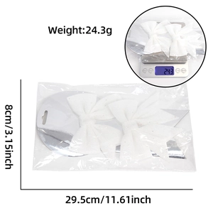 Pair of white glitter Christmas bows with silver sequins and size measurement details