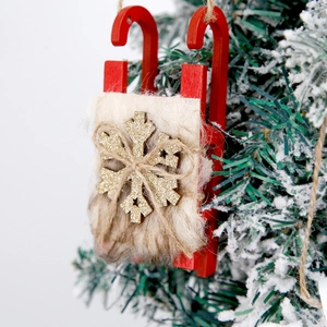 Christmas wooden sleigh ornament with faux fur and golden snowflake on festive tree