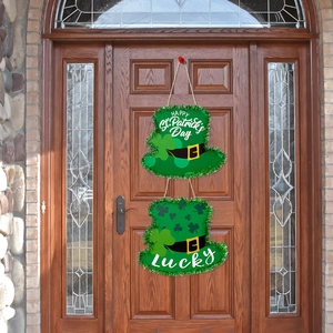 Detail of St. Patrick's Day green hat door hangers with Lucky text on wooden door