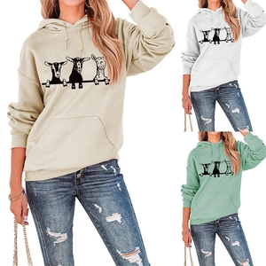 Detailed view of women's hoodie featuring whimsical goat print and front pouch pocket