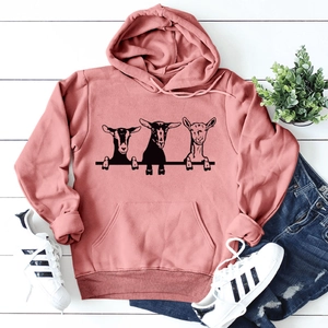 Brick red oversized hoodie with goats print on white wood floor background