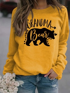 Close-up of Grandma Bear letter print and bear silhouette on yellow sweatshirt