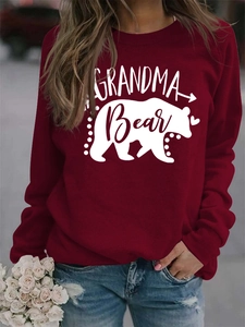 Close-up of white GRANDMA Bear print and bear silhouette on dark red sweatshirt