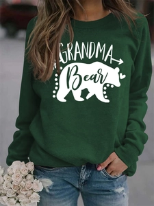 Detail of Grandma Bear print on dark green sweatshirt with heart and arrow motifs