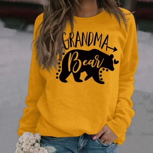 Detail view of mustard yellow sweatshirt with black Grandma Bear print and ribbed cuff detail