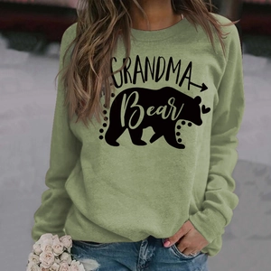 Detailed close-up of Grandma Bear letter print and bear silhouette on olive green sweatshirt