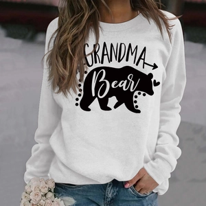 Detail of Grandma Bear print on a white long-sleeved sweatshirt with denim jeans
