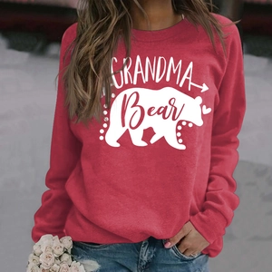 Detail of red Grandma Bear sweatshirt with screen-printed white graphics and floral accent