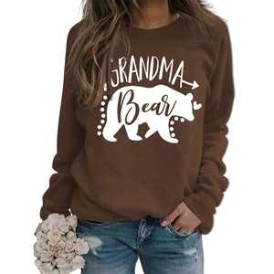 Detail of Grandma Bear print on brown long sleeve sweatshirt with white floral prop