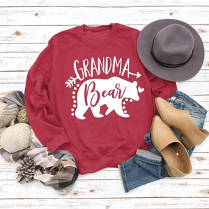 Close-up of Grandma Bear letter print on a dark red long sleeve sweatshirt flat lay