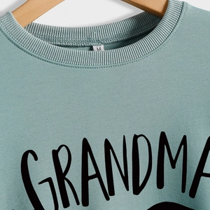 Sage green Grandma Bear letter print sweatshirt with ribbed crew neck on hanger