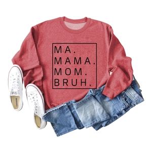 Flat lay of brick red sweatshirt featuring MA MAMA MOM BRUH slogan print and blue jeans