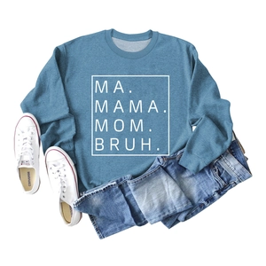 Flat lay of blue crewneck sweatshirt with MA MAMA MOM BRUH text and denim styling
