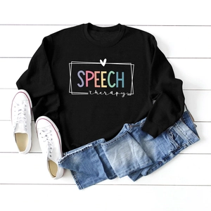 Flat lay of black crewneck sweatshirt with colorful Speech Therapy graphic print