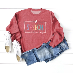 Flat lay detail of red sweatshirt featuring SPEECH therapy print and heart heart border