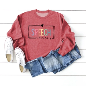 Flat lay of red long sleeve sweatshirt with Speech Therapy print and denim jeans