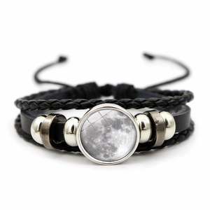 Detailed view of multilayer braided leather bracelet with realistic moon glass gemstone