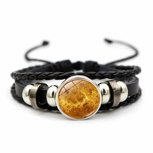 Macro view of multi-layer leather bead bracelet with moon glass charm and adjustable cords