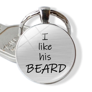 Detail view of round keychain featuring I like his BEARD text under glass dome