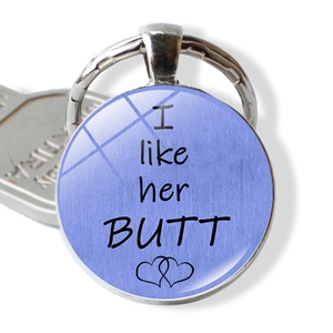 Detailed macro view of funny silver keychain featuring I like her BUTT text and hearts