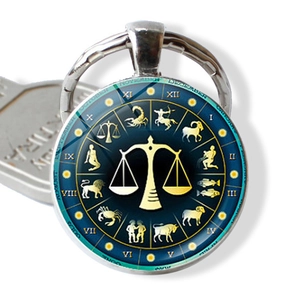 Macro view of Libra zodiac glass pendant keychain with constellation dial and silver frame