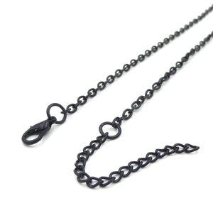 Detail view of the black metal chain with a lobster clasp and adjustable extender links