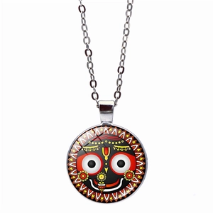 Macro view of Lord Jagannath pendant with vibrant cabochon glass and silver chain